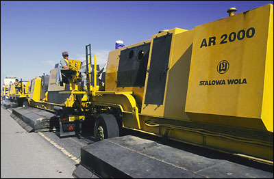 Photograph -- Rehabilitating the highways: Fresh asphalt re-paving.