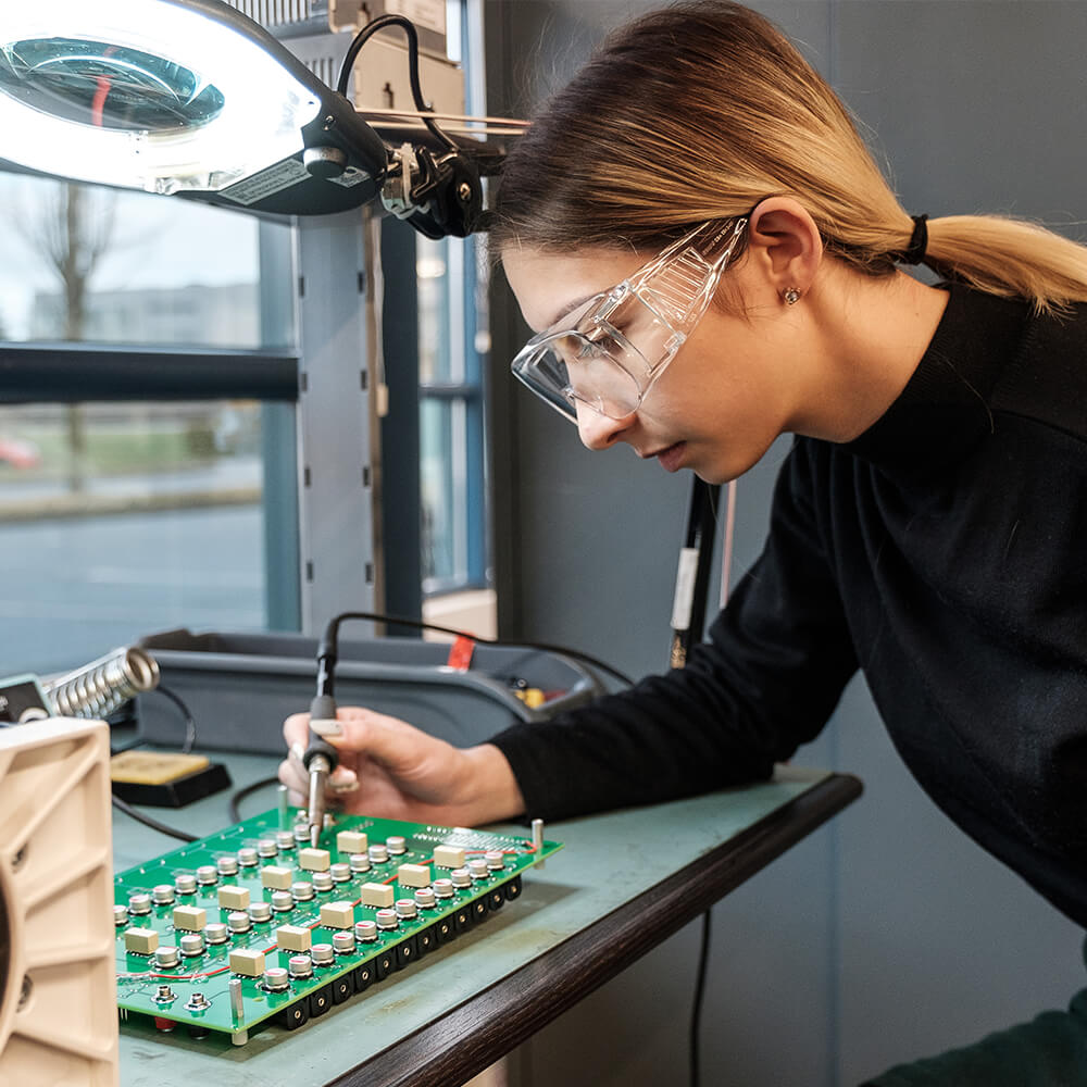 an engineer checking a circuit board