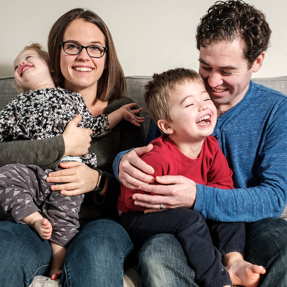 a young happy family sitting on a couch