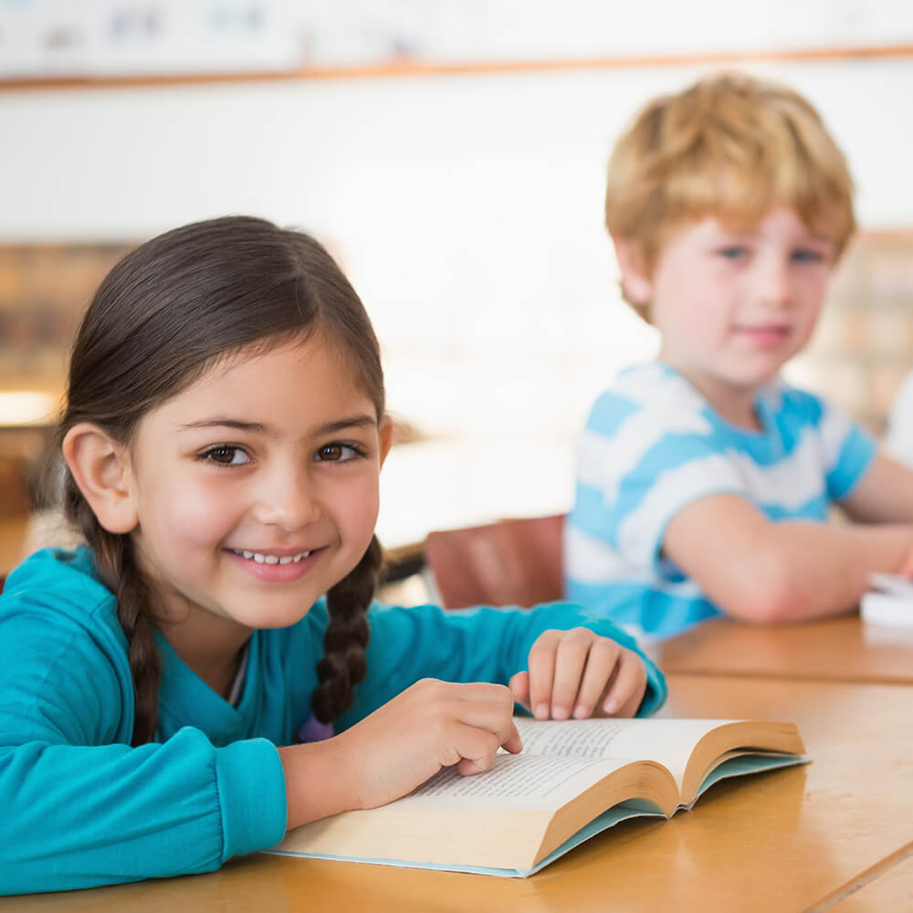 two young students smiling at the camera